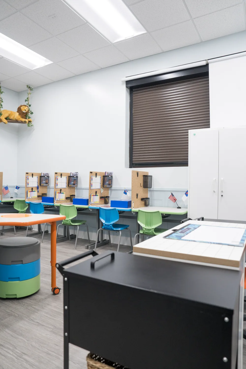 Individual study stations beside a classroom window.