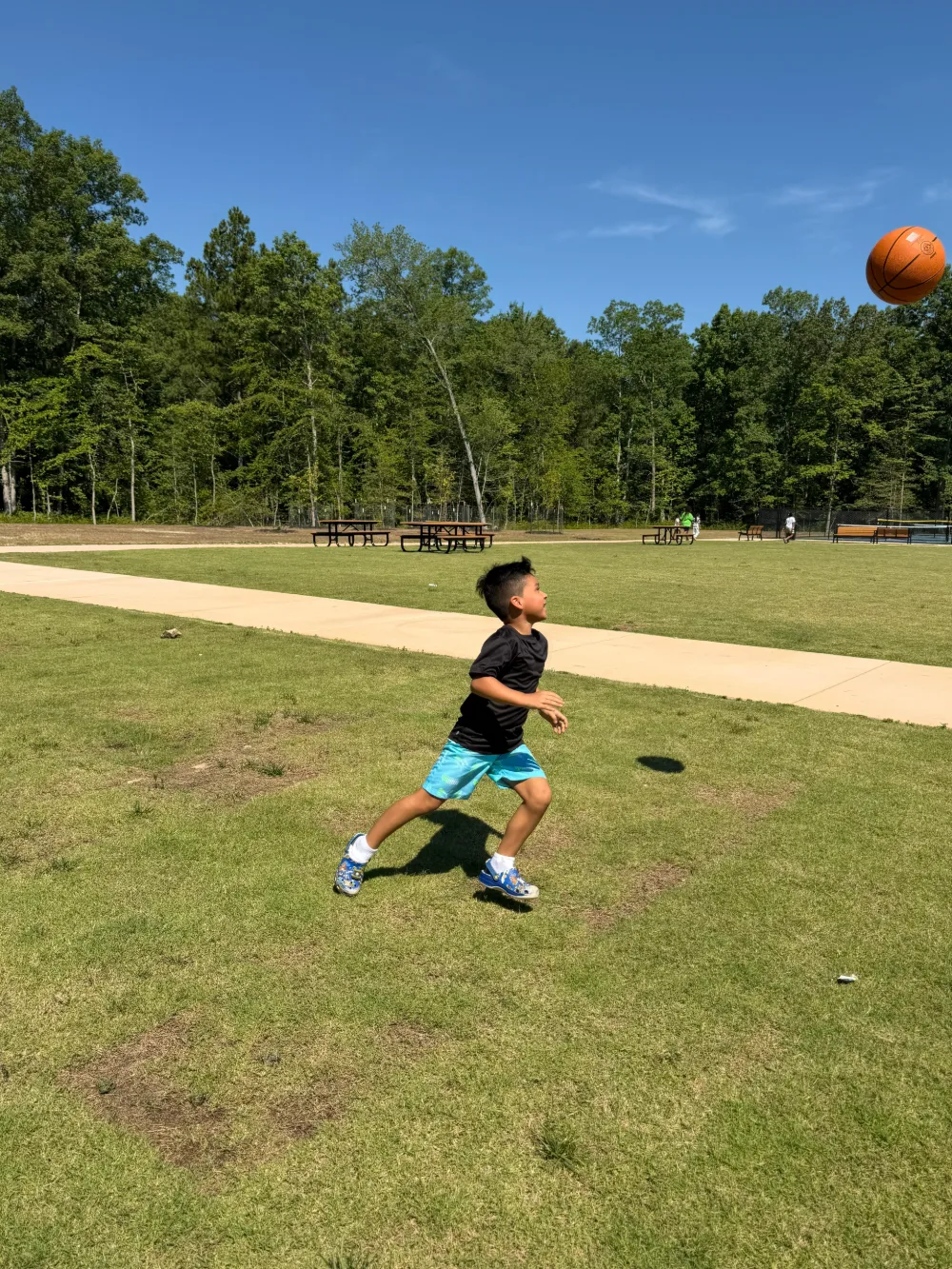 Students taking part in an outdoor activity day on an open field.
