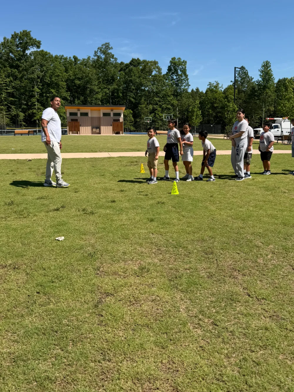 A group of students on an open field during an activity day.