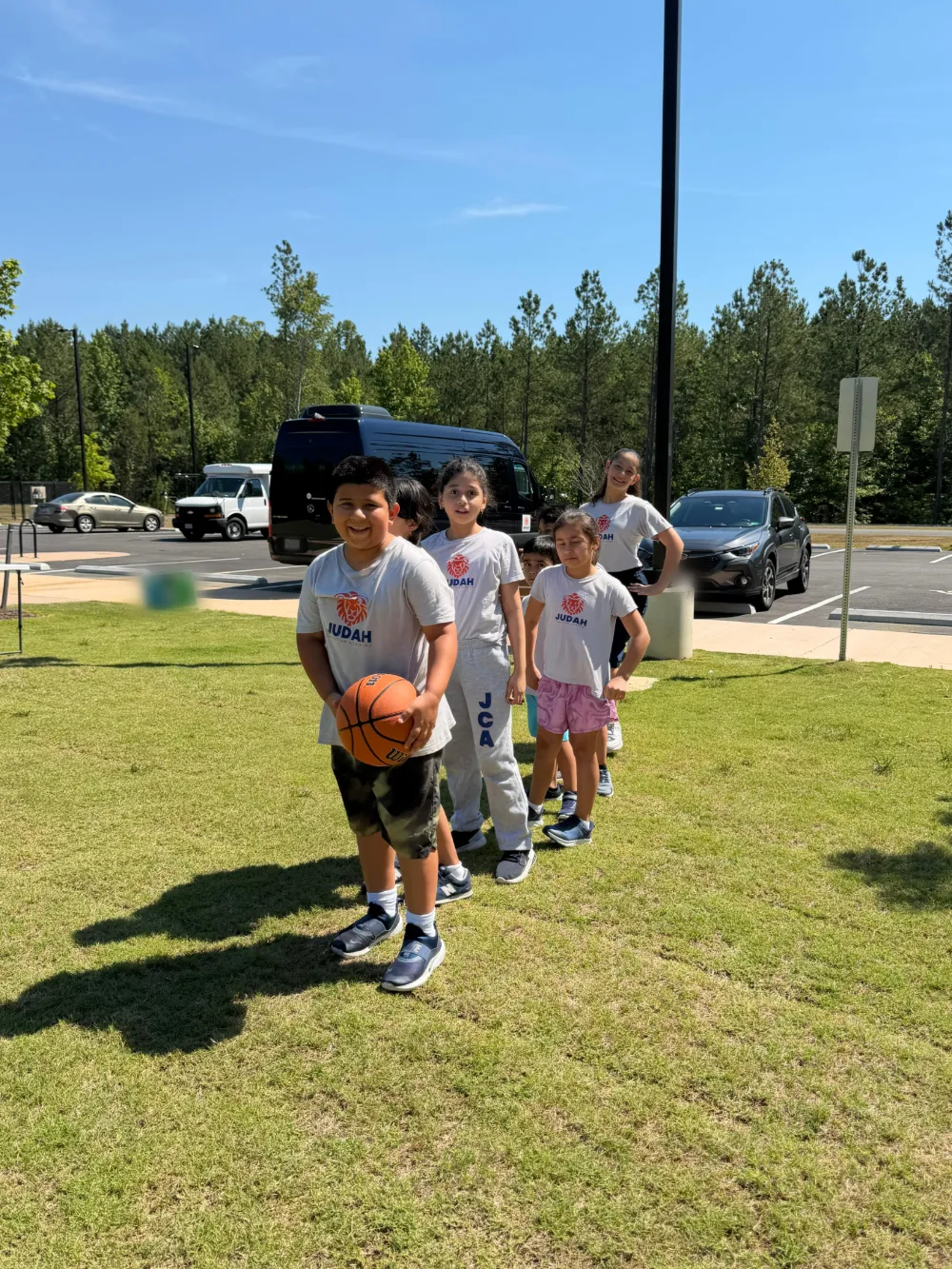 Students taking part in an outdoor activity on the grass.