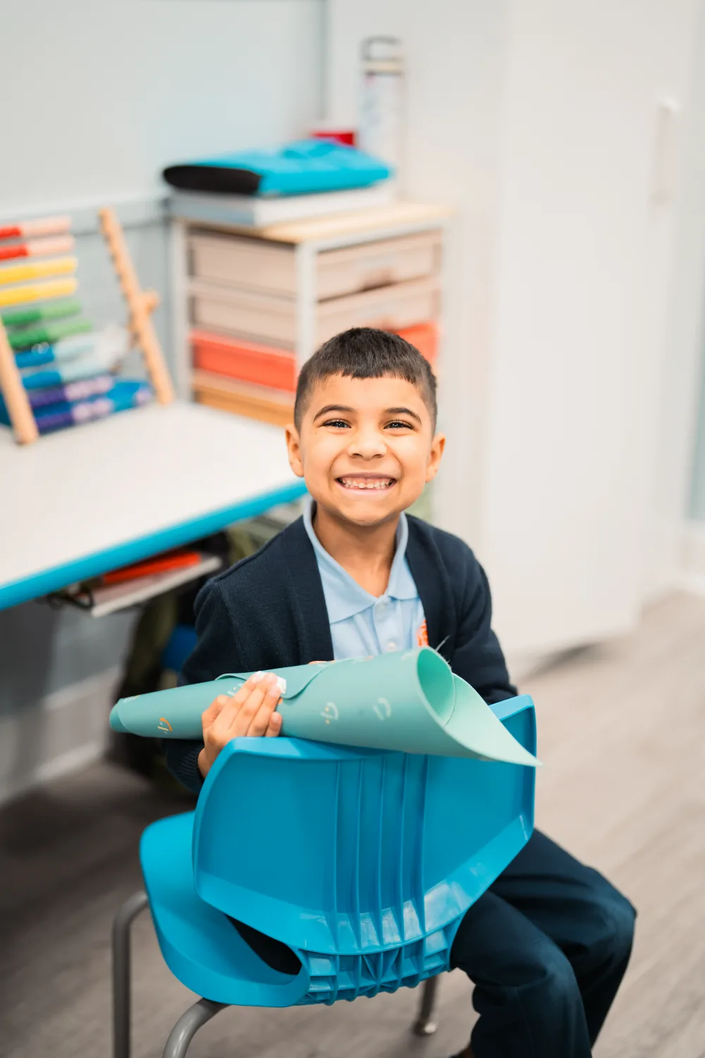 A Judah Christian Academy student in a navy sweater, smiling at the camera.